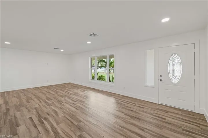 Entryway with light wood-style floors and recessed lighting