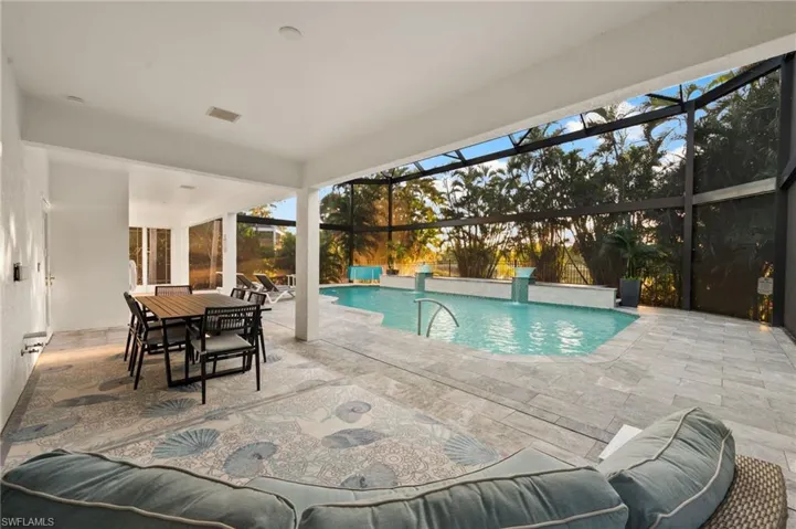Outdoor pool featuring a patio area, and a under truss lanai plumbed and ready for your outdoor kitchen touch.