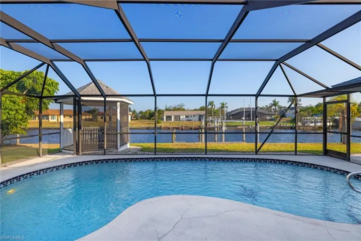 View of swimming pool with a lanai