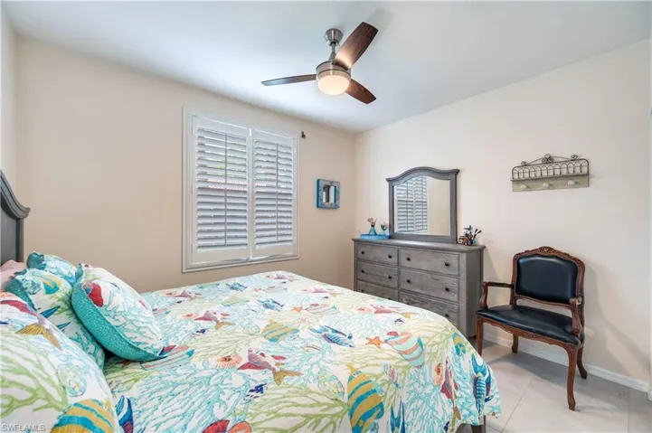 Bedroom with a ceiling fan and baseboards