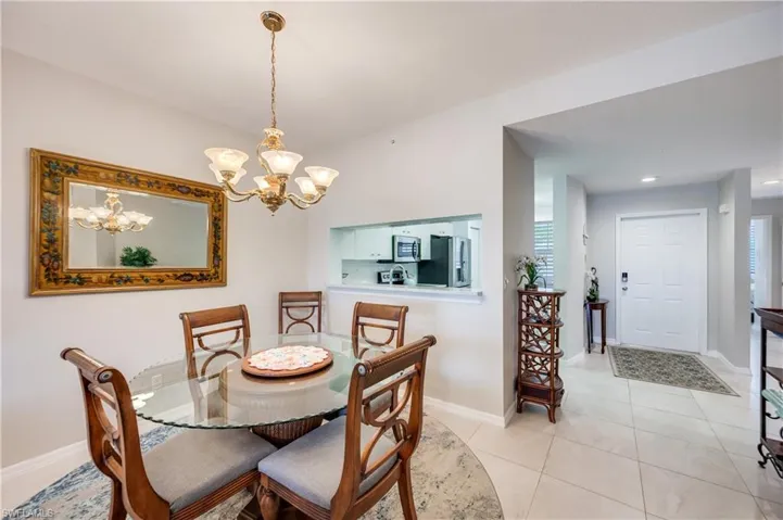 Dining space featuring a chandelier and light tile patterned floors
