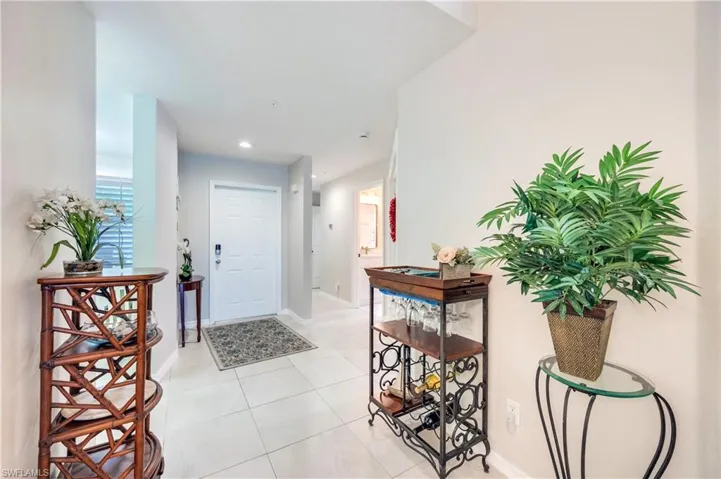 Entrance foyer featuring light tile patterned floors and recessed lighting
