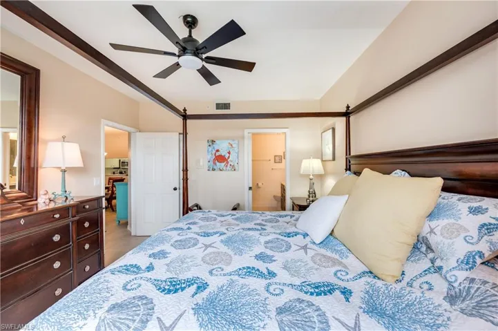 Bedroom with ceiling fan and ensuite bathroom
