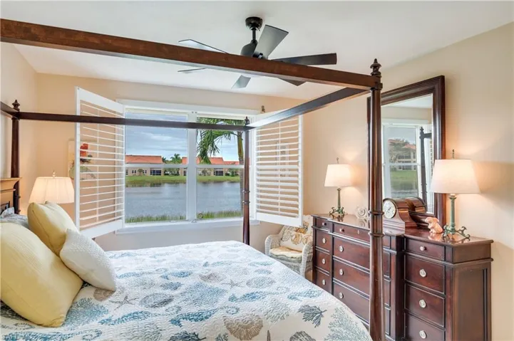 Bedroom featuring ceiling fan and a water view