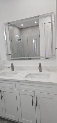 Full bathroom with a shower stall and double vanity