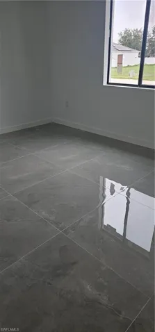 Empty room featuring baseboards