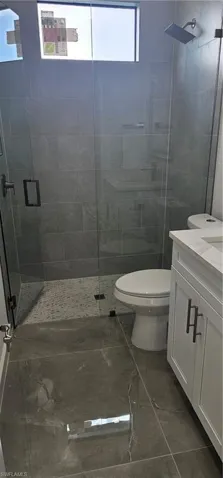 Full bath with vanity and a stall shower