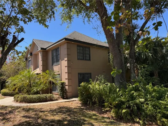 View of home's exterior with stucco siding and roof with shingles
