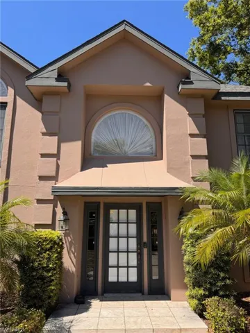Property entrance with stucco siding