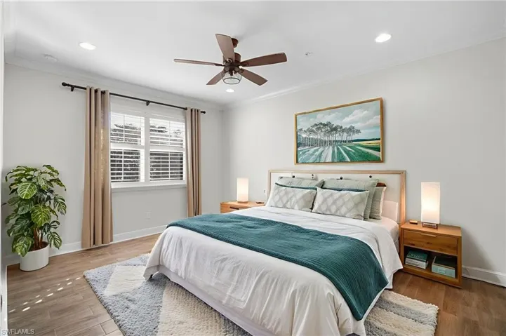 Bedroom with crown molding, wood finished floors, a ceiling fan, and recessed lighting