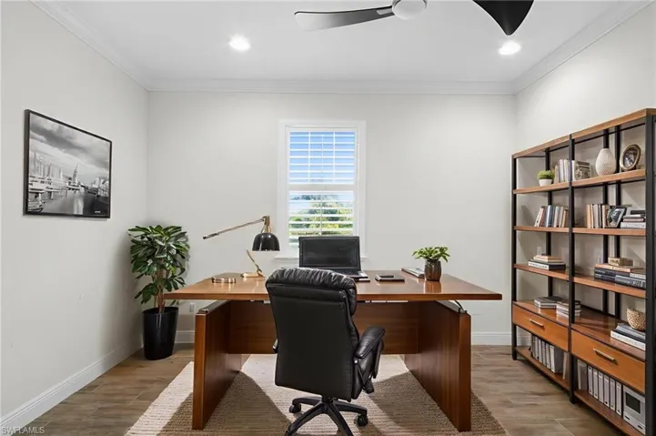 Office space featuring light wood-type flooring, ornamental molding, a ceiling fan, and recessed lighting