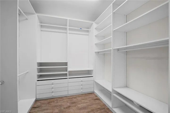 Spacious closet featuring wood finished floors