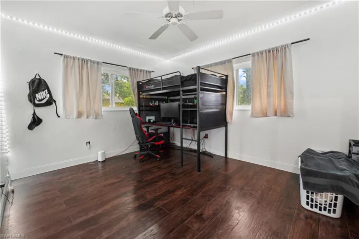 Bedroom featuring wood-type flooring and ceiling fan
