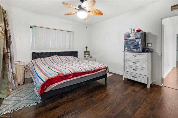 Bedroom featuring dark wood-type flooring and ceiling fan