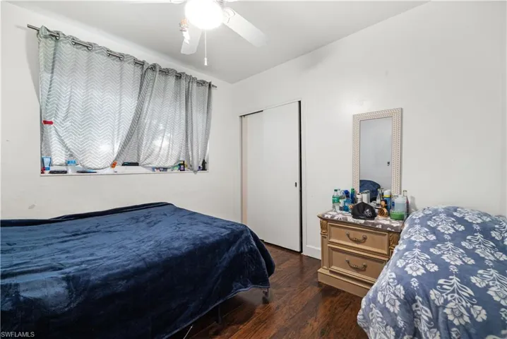 Bedroom featuring ceiling fan and dark hardwood / wood-style flooring