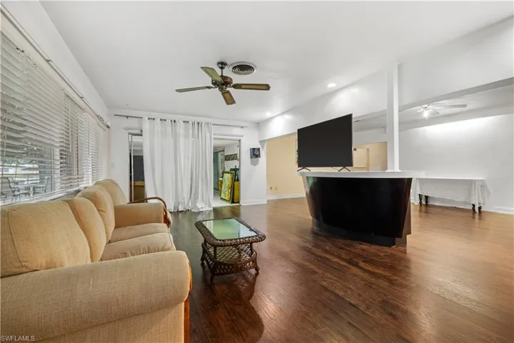Living room featuring ceiling fan and hardwood / wood-style floors