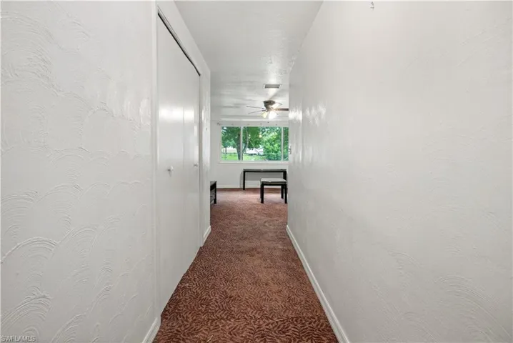 Hallway featuring carpet