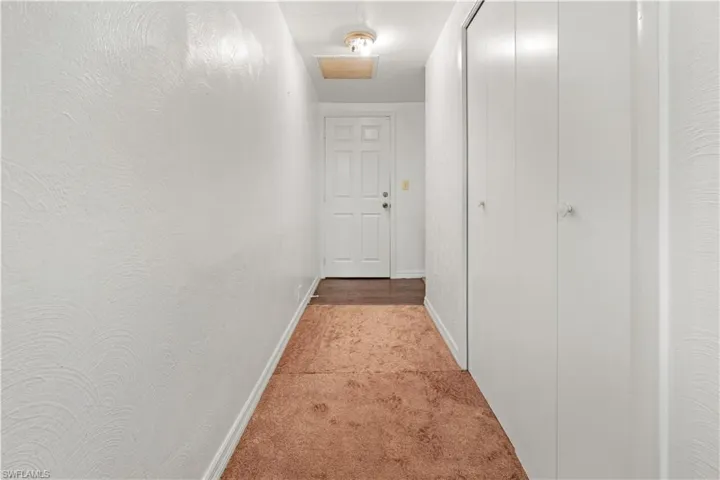 Hallway featuring carpet floors in apartment