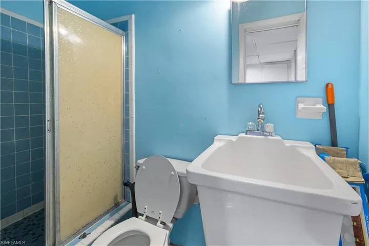 Bathroom with sink, walk in shower, and toilet