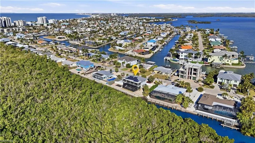 Aerial overview of property's location featuring nearby suburban area and a nearby body of water - Virtually Edited Image