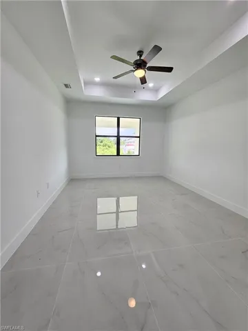 Large Master room featuring ceiling fan and a tray ceiling