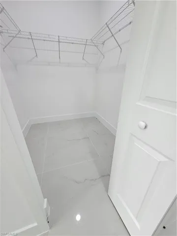Walk in closet featuring tile patterned flooring
