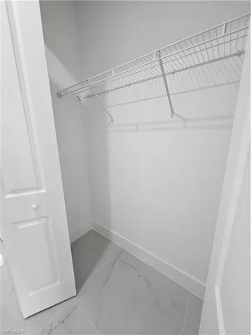 Spacious closet featuring light tile patterned floors