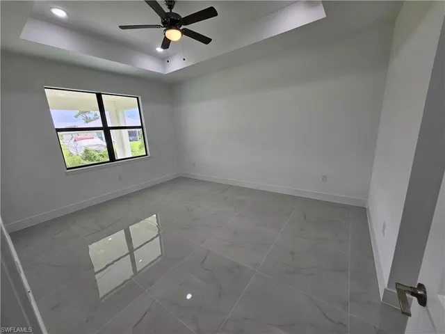 Tiled Master with ceiling fan and a raised ceiling