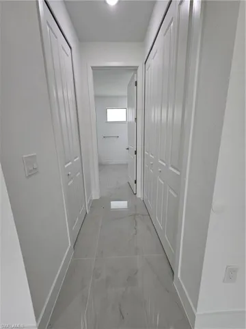 Corridor with light tile patterned floors