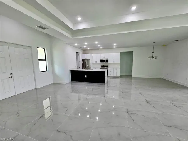 Unfurnished living room with light tile patterned floors