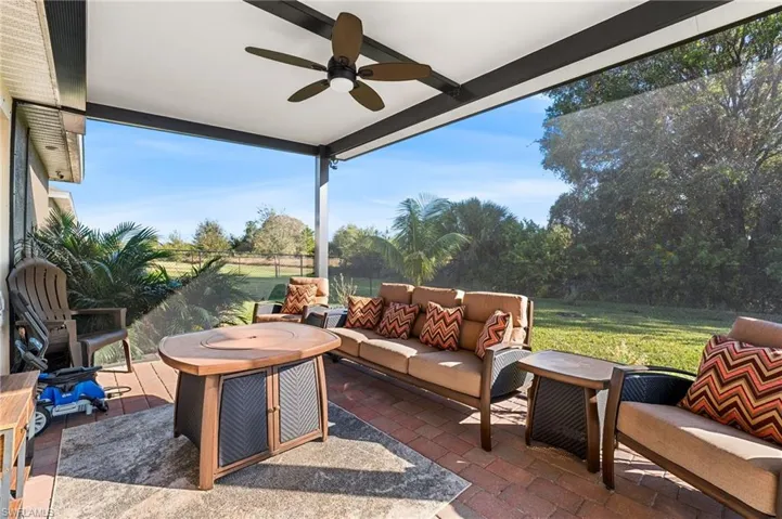 View of patio with outdoor lounge area and ceiling fan
