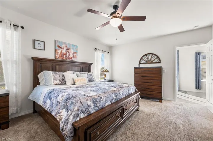 Carpeted bedroom with ceiling fan