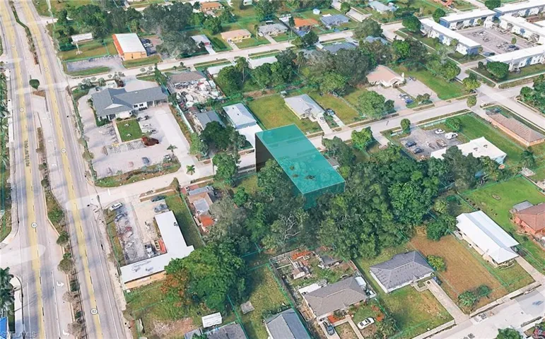 Aerial view of property's location with nearby suburban area
