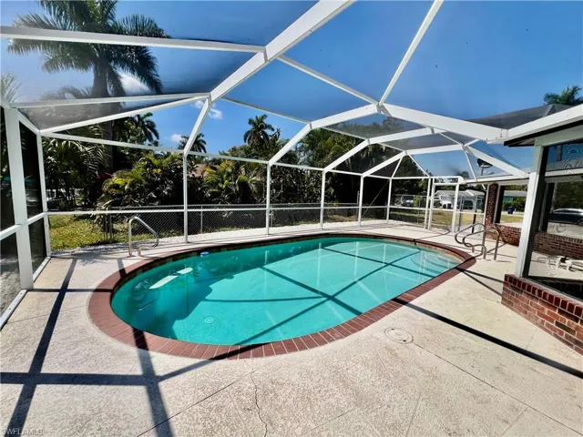 Pool with a patio area and screen enclosure