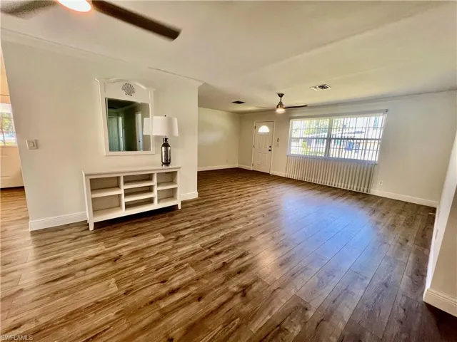 Living room featuring crown molding, LUXURY VINYL PLANK FLOORS.