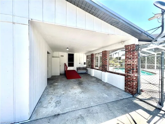 Carport and entrance to storage room/workshop.