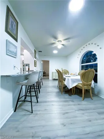 Dining area featuring light wood-style flooring and ceiling fan