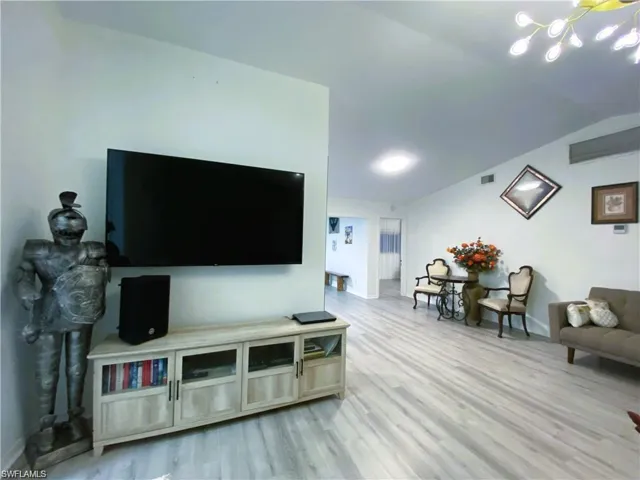 Living area featuring light wood-style floors and baseboards