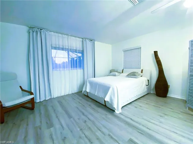Bedroom with wood finished floors and ceiling fan