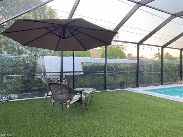 Swimming pool with a patio area, a sunroom