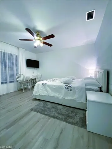 Bedroom with light wood finished floors and ceiling fan