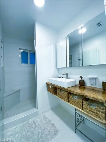 Full bathroom with a stall shower and vanity