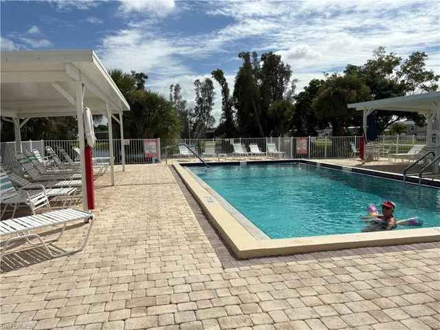 Community pool with a patio area and a gazebo