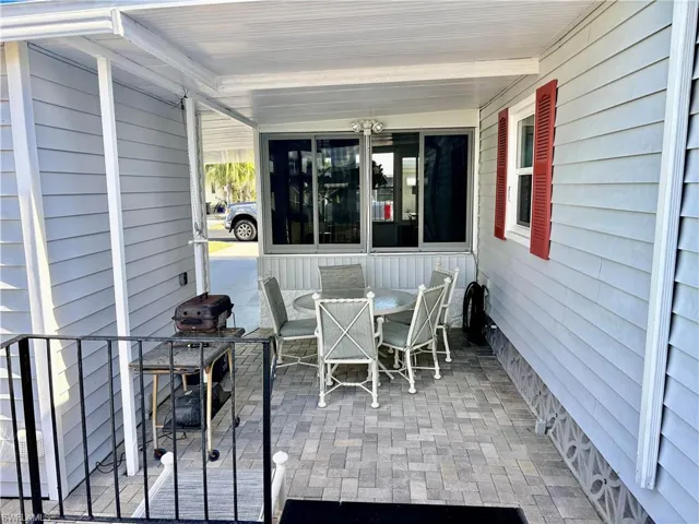 Porch featuring outdoor dining area