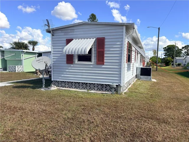 View of side of home featuring a yard