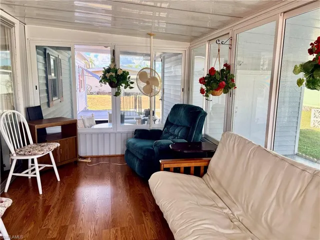 Sunroom / solarium featuring wood finished floors