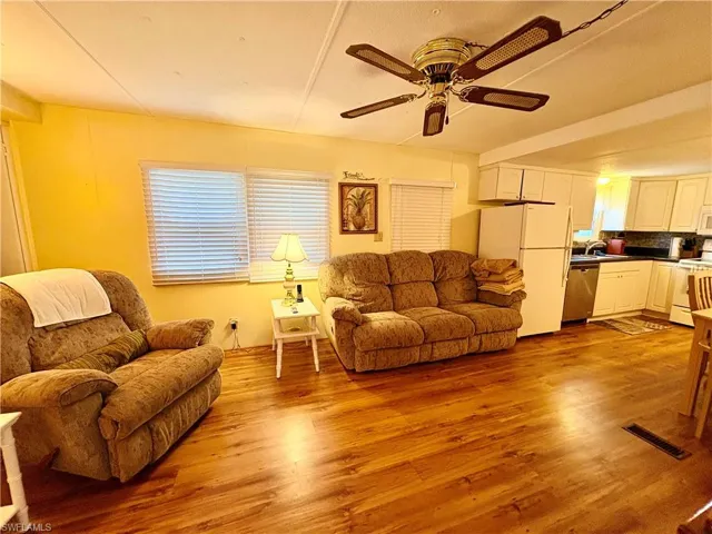 Living area featuring light wood-style flooring and a ceiling fan