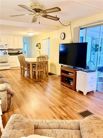 Living room featuring a ceiling fan and light wood finished floors