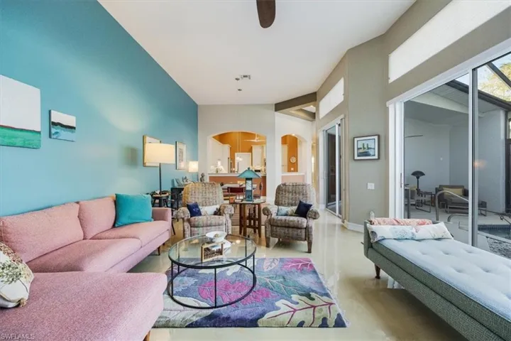 Living area with lofted ceiling, baseboards, arched walkways, and beautiful concrete painted floors giving this a sophisticated palette for the discerning buyer