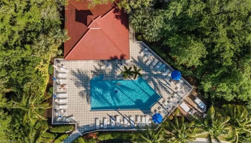 Birds eye view of community pool with clubhouse that can be reserved for larger gatherings